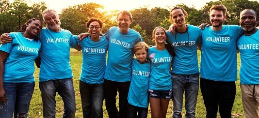 Find out more about Community Champions. Photo of people wearing 'Volunteer' t-shirts