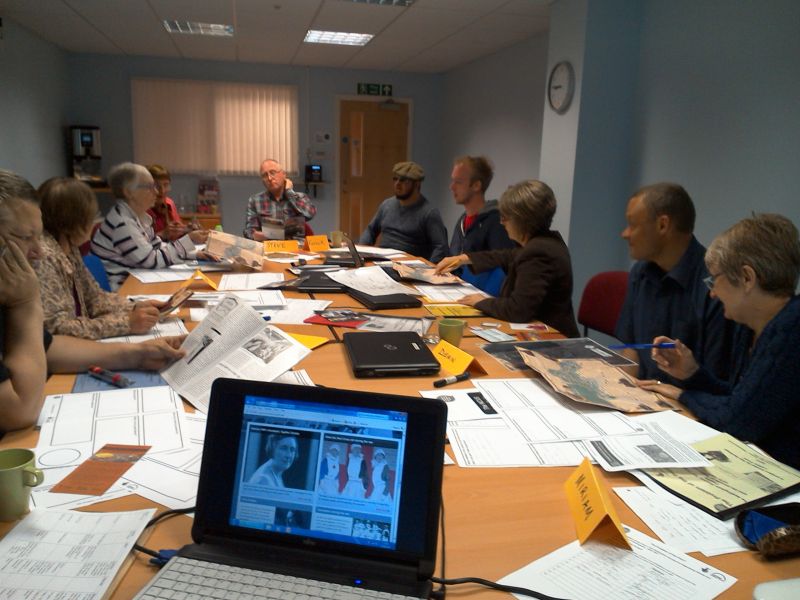 Volunteers discussing heritage documents