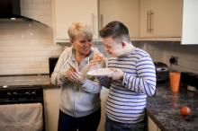 Two people pictured in kitchen promoting Warm Homes Hub